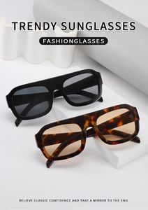 Close-up of trendy square sunglasses in black and leopard patterns on geometric props