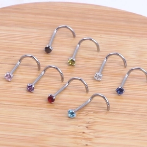 Set of 8 colorful zircon L-shaped nose rings with surgical steel posts on wood