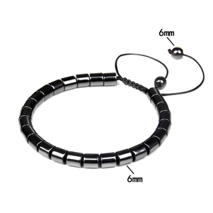 Detail view of 6mm hematite beads on a black woven adjustable bracelet with metallic finish