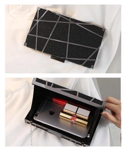 Detail of geometric evening clutch showing interior space for phone and lipstick