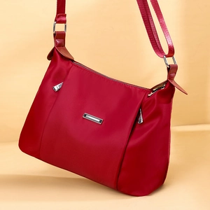 Waterproof red oxford nylon crossbody bag for women with silver metal hardware and adjustable strap
