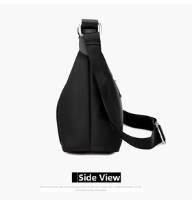 Side view of black canvas crossbody bag with silver D-rings and adjustable strap