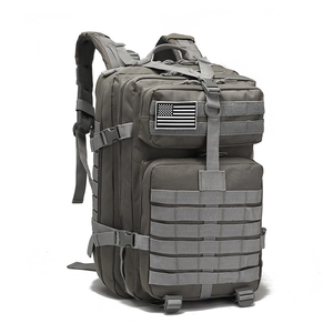 Detail view of the durable gray tactical backpack showing MOLLE system and side compression straps