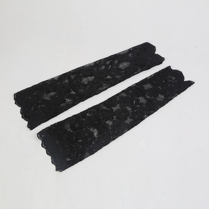 Detailed view of long black floral lace arm sleeves with elegant scalloped edge finish