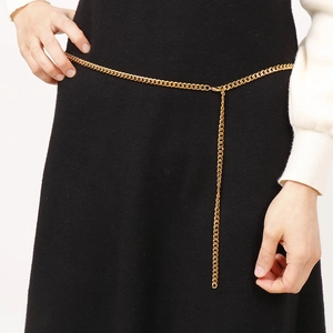 Elegant gold titanium steel yoga chain belt for women on a stylish black dress