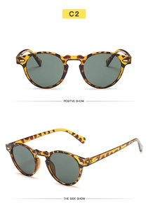Close-up view of vintage round tortoiseshell sunglasses with dark lenses and retro frame