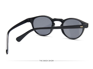 Detailed back view of vintage black round sunglasses showing golden hinge accents