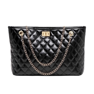 Classic black quilted tote bag with golden chain straps and rectangular twist lock detail