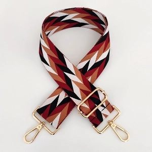 Ethnic style woven wide shoulder strap with red and brown chevron pattern and gold hooks