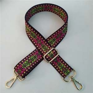 Detail of adjustable colorful ethnic pattern bag strap with gold metal lobster clasps