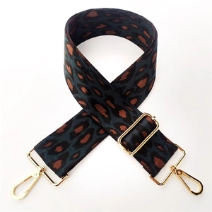 Close-up of thick leopard jacquard strap with gold metal hardware and lobster clasps