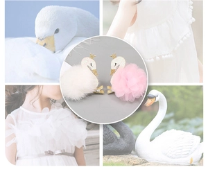 Detail of white plush and pink mesh swan hair clips with gold crown accents for girls