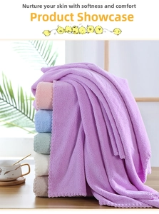 Detail of coral fleece towels showing soft texture and scalloped wavy edge stitching