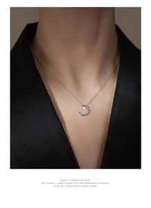 Detail of 925 sterling silver moon and star pendant necklace with cubic zirconia