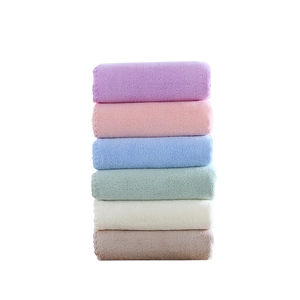 Set of 6 soft coral fleece towels in pastel colors stacked neatly on white background