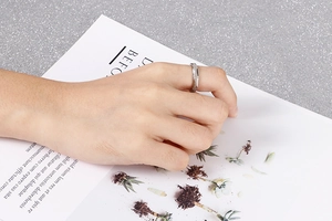 Detailed close-up of a silver matte titanium steel bamboo joint ring worn on finger