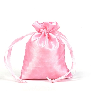Close-up of pink satin drawstring pouch with smooth silk texture for jewelry storage