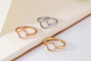 Three heart-shaped rings with loose diamonds in silver, rose gold and gold finishes