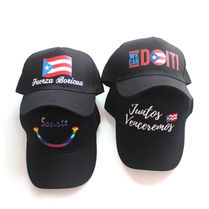 Detail view of black baseball caps with various colorful Puerto Rico flag prints