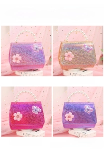 Detailed view of kids sequin handbags with pearl handles in pink, gold, rose, and purple