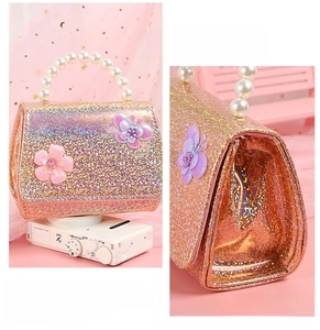 Detail of pink sequins, 3D butterfly floral decor, and pearl handle on mini bag