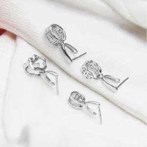 Macro shot of four S925 sterling silver pendant pinch bails with intricate floral patterns