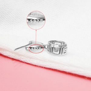 Macro shot of S925 sterling silver pinch bail with clear hallmark stamp detail