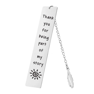 Detailed macro view of silver stainless steel bookmark with feather pendant and engraving