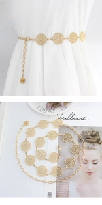 Detail of gold hollow circle leaf chain belt with adjustable lobster clasp on white dress