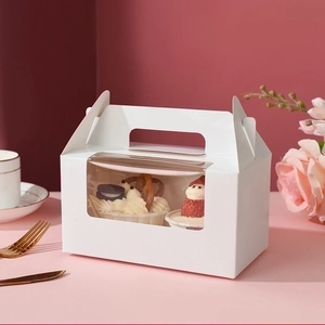 White 2-slot cupcake box with window and handle displayed in an elegant tea setting