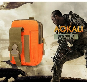 Detail of orange tactical waist bag showing MOLLE webbing and secure plastic buckle
