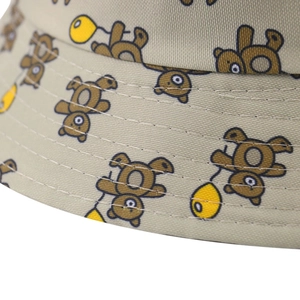 Detailed view of khaki sun hat with cartoon bear print and neat stitching craftsmanship