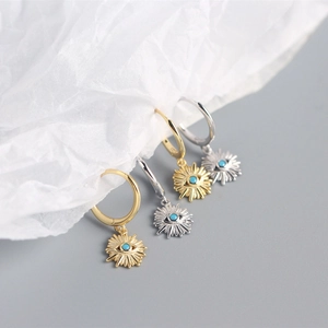 Macro view of gold and silver S925 sterling silver evil eye hoop earrings with zircon