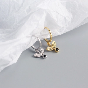 Detailed close-up of S925 silver peace dove hoop earrings in gold and silver finishes
