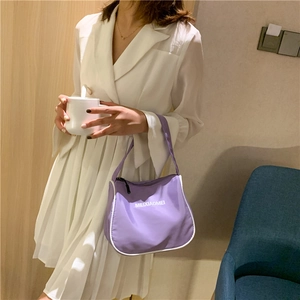 Purple nylon crescent shoulder bag with white piping and letter print shown by model