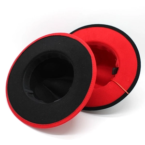 Detail of red and black color-block wool fedora hats with stitched care labels