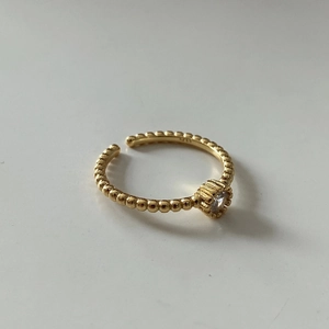 Macro detail of gold-plated 925 sterling silver beaded ring featuring S925 hallmark