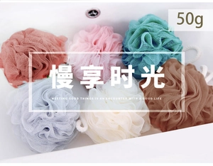 Macro view of 50g macaron colored soft bath mesh balls with hanging ropes in a white sink