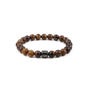 Macro detail of natural tiger eye stone beads with polished brown silk luster texture