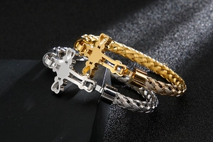 Macro shot of gold and silver braided stainless steel bracelets with cross charms