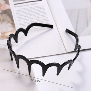 Detail shot of black wavy plastic headband with 12.5CM width measurements for women