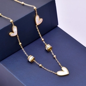 Golden titanium steel necklace featuring white heart pendants and zircon cylinder beads