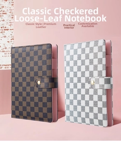 Detail of A5 binder notebook with grid pattern leather cover and snap button closure