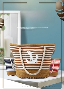 Detailed view of striped canvas beach tote bags with anchor print and rope handles
