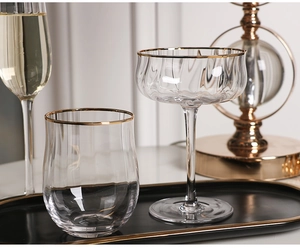 Detail of ribbed glass cups with gold rim showing elegant textured finish and design