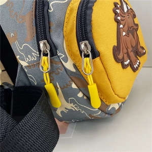 Detail of dinosaur crossbody bag featuring durable canvas fabric and dual zipper design