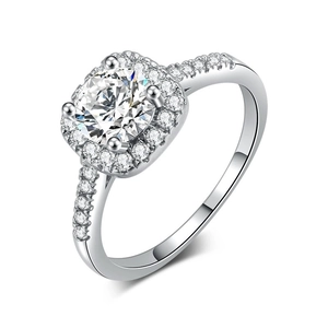 Close-up of four-prong round zircon with halo setting and side stones on silver ring