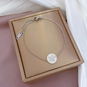 Silver star pendant chain bracelet with crystal accents in an elegant jewelry box