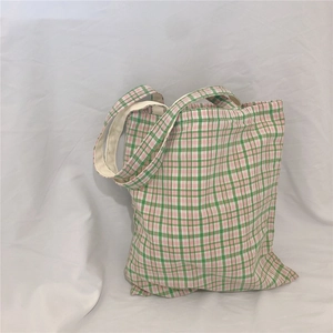 Detail of pink and green plaid canvas tote bag showing soft texture and spacious design