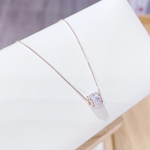 Rose gold cylinder necklace with micro-pave zircons on an elegant display stand